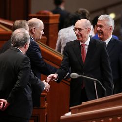 President Henry B. Eyring, first counselor in the First Presidency, center right, and President Dieter F. Uchtdorf, second counselor in the First Presidency, right, greet the other members of the Quorum of the Twelve Apostles in the Conference Center in Salt Lake City during the afternoon session of the LDS Church’s 187th Annual General Conference on Sunday, April 2, 2017.