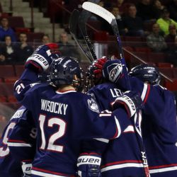 UConn celebrates after their first goal against the UMass Minutemen men's college hockey game at the Mullins Center in Amherst, MA on December 1, 2017.