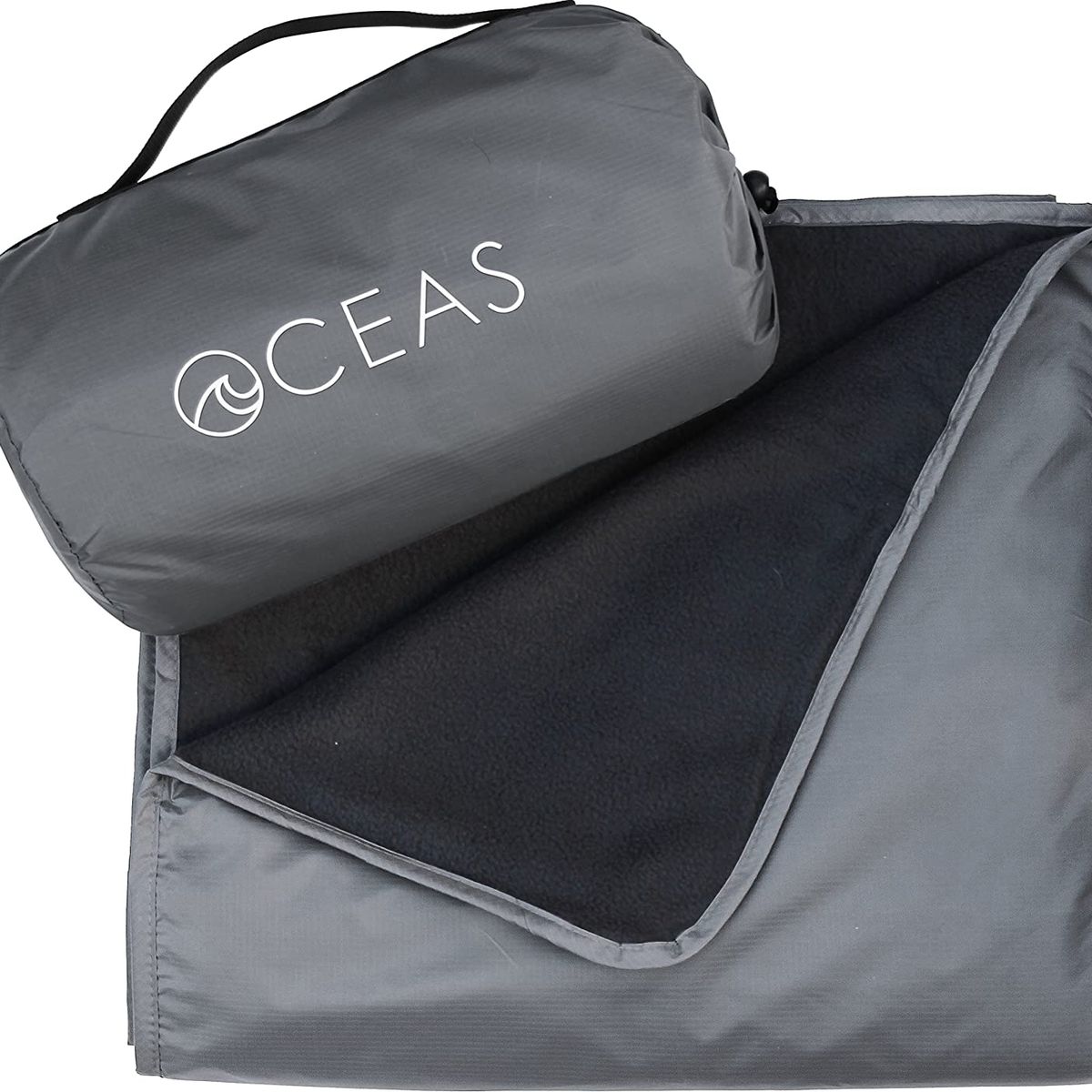 A gray blanket with black fleece on one side and a carrying case 