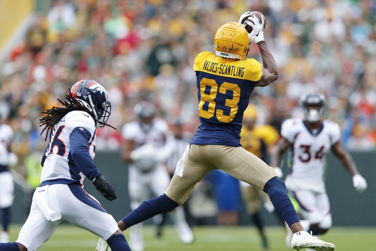 Green Bay Packers wide receiver Marquez Valdes-Scantling catches a pass in front of Denver Broncos safety Trey Marshall during the first quarter at Lambeau Field.