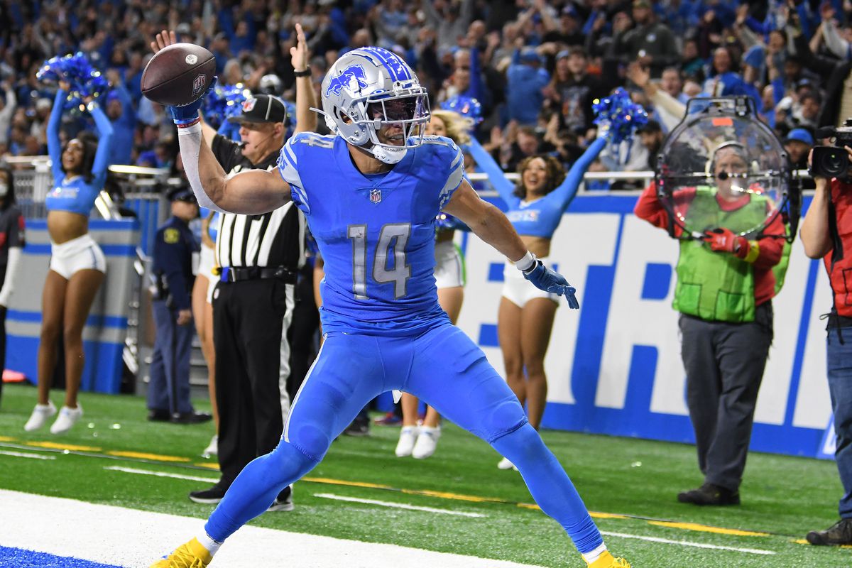 Detroit Lions wide receiver Amon-Ra St. Brown (14) celebrates by throwing the football into the end zone wall after scoring a touchdown on a pass from quarterback Jared Goff (not pictured) against the Jacksonville Jaguars in the fourth quarter at Ford Field.