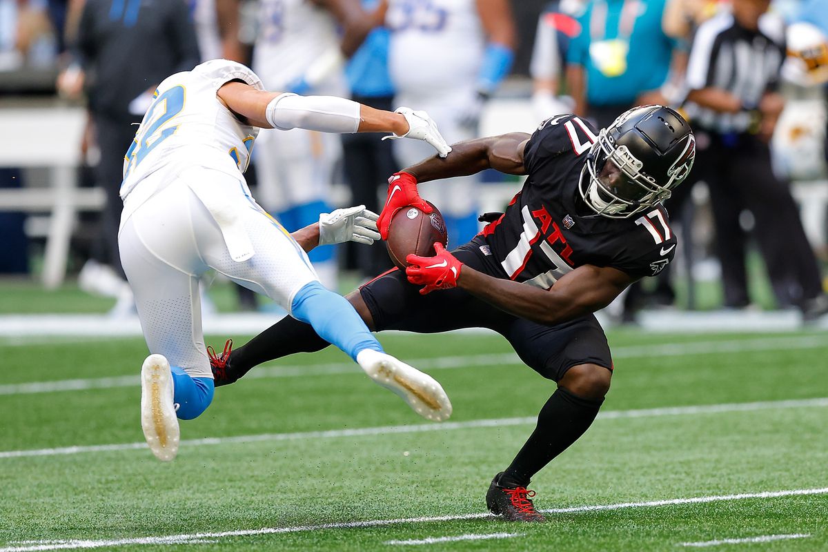 Olamide Zaccheaus #17 of the Atlanta Falcons catches a pass while defended by Alohi Gilman #32 of the Los Angeles Chargers during the third quarter at Mercedes-Benz Stadium on November 06, 2022 in Atlanta, Georgia.