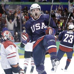 USA's Bobby Ryan celebrates after scoring against Switzerland goalie Jonas Hiller, left, during men's hockey preliminary game at the Vancouver 2010 Olympics Tuesday. The Americans won, 3-1.