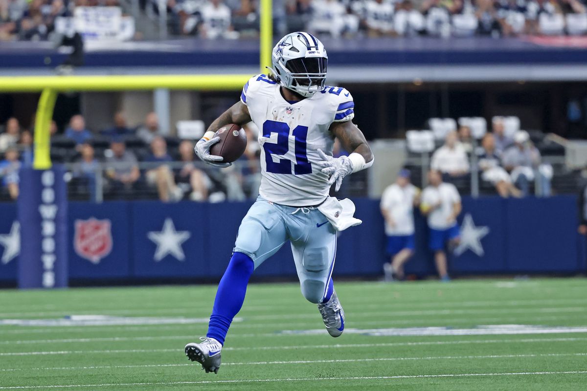 Dallas Cowboys running back Ezekiel Elliott (21) runs with the ball during the first half against the Detroit Lions at AT&amp;T Stadium.