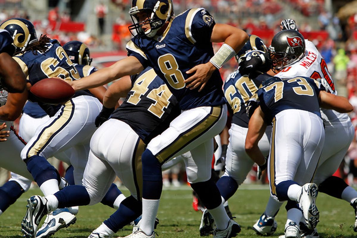 Quarterback Sam Bradford #8 of the St. Louis Rams hands the ball off against the Tampa Bay Buccaneers during the game at Raymond James Stadium on October 24 2010 in Tampa Florida.  