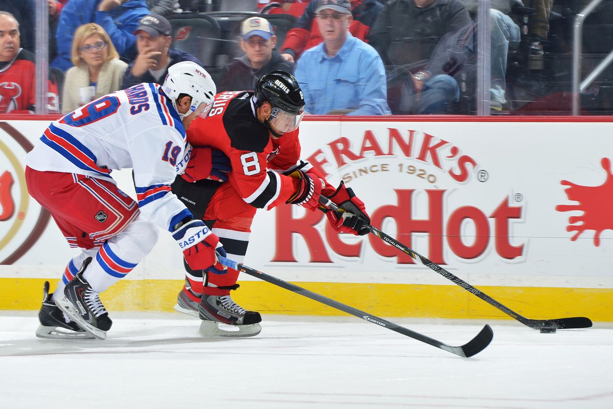 The New Jersey Devils finally got a win and are now just ahead of the New York Rangers in the division standings. Just like Dainius Zubrus is just ahead of Brad Richards in this photo.