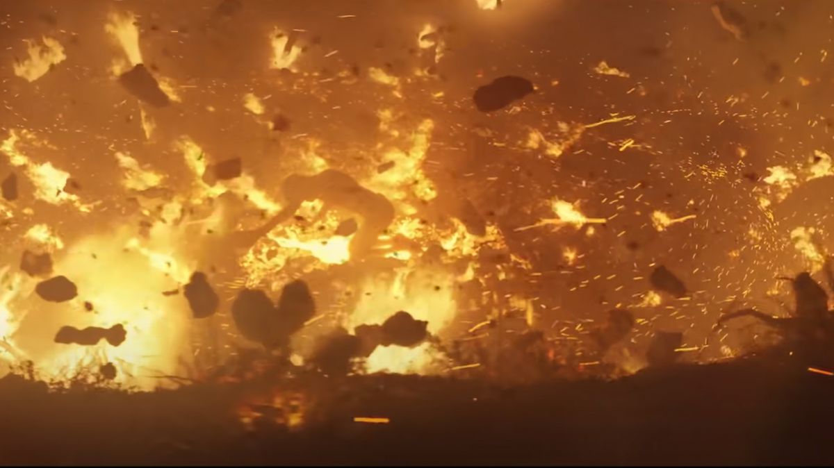 Screencap of Rings of Power trailer showing a guy in the middle of a fiery cataclysm.