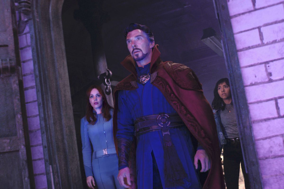 doctor strange standing in a doorway with christine palmer and america chavez standing behind him