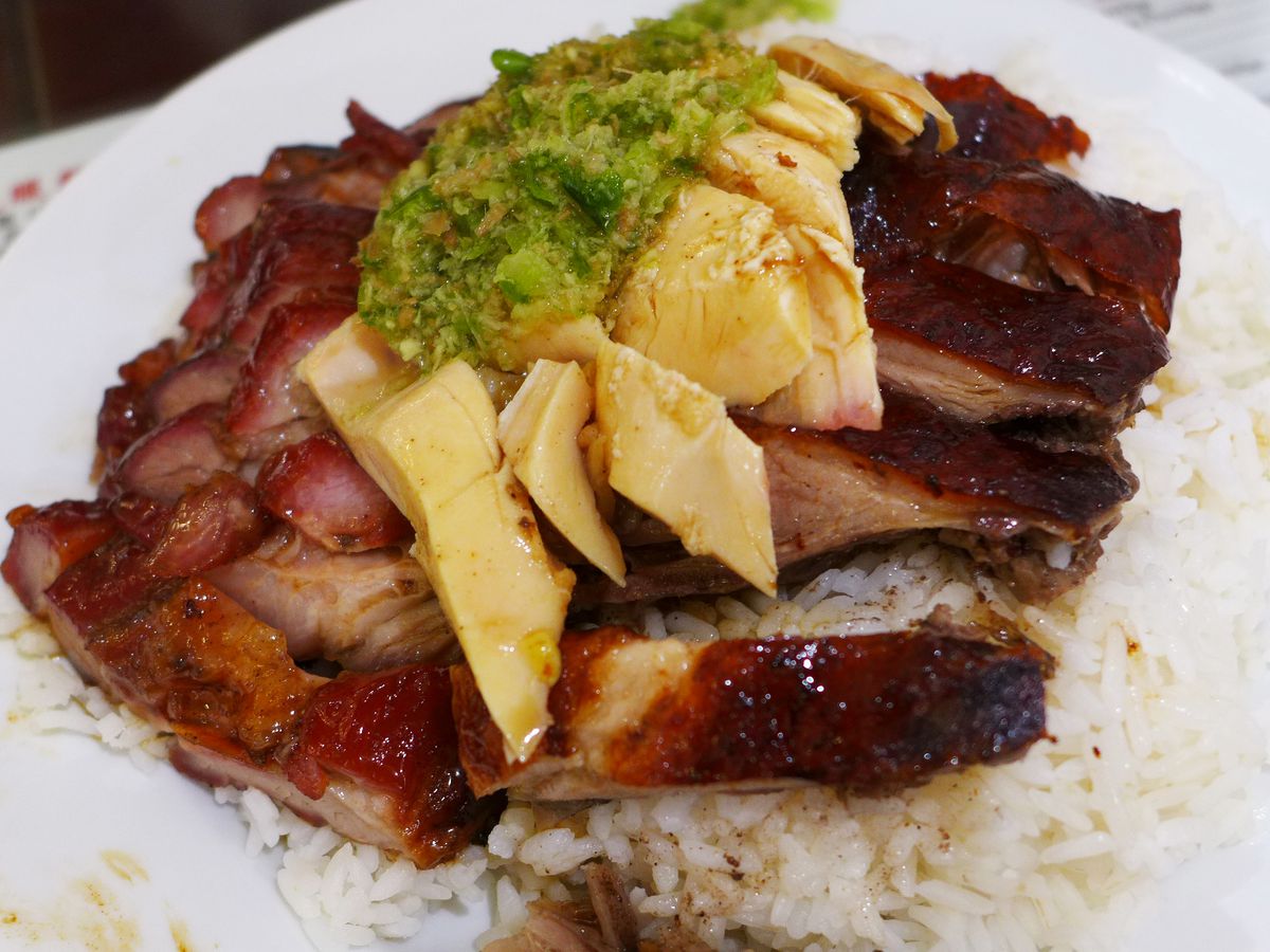 Three meats with green sauce on top heaped on rice.