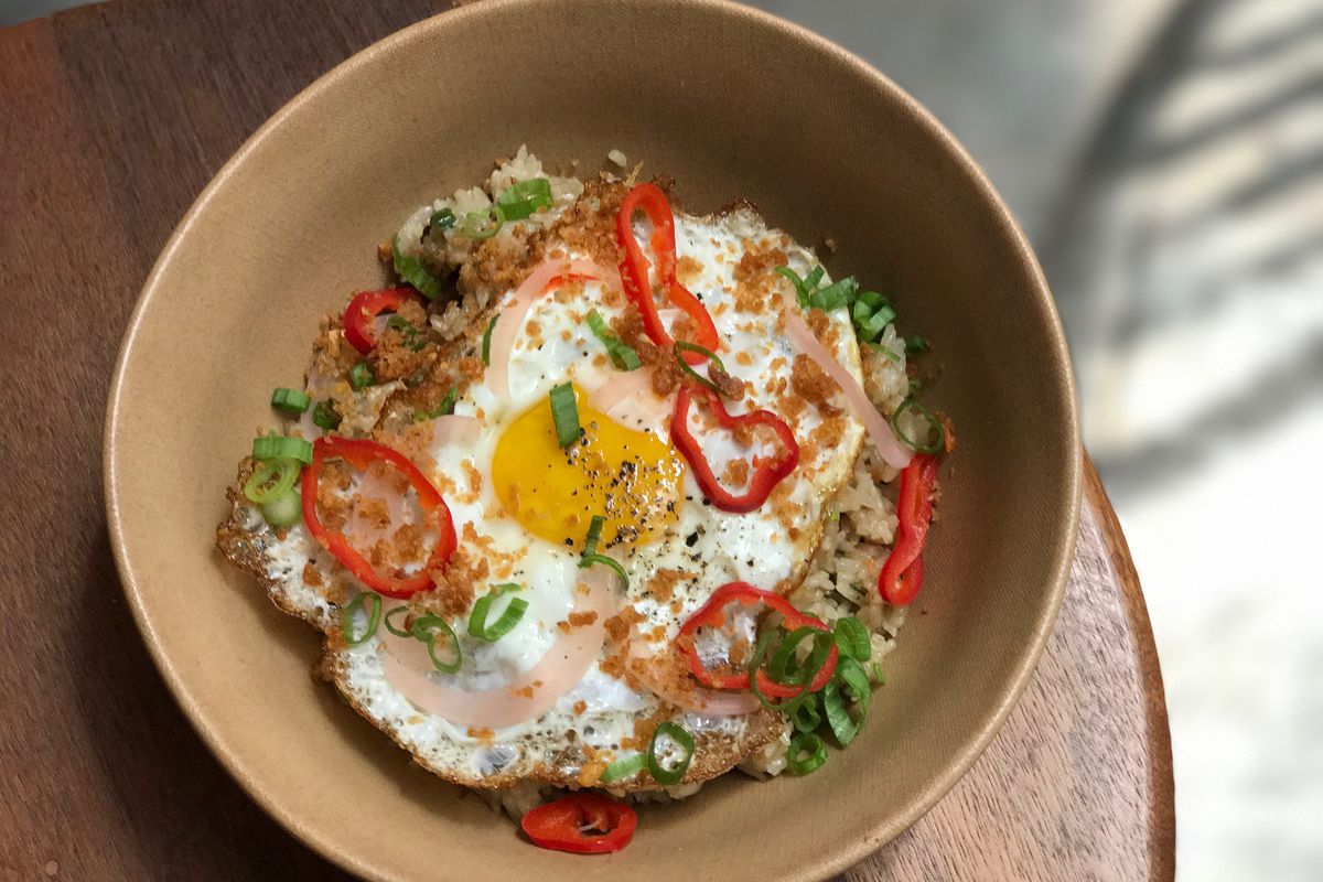 Sunny eggs in a bowl with rice.