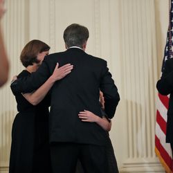 President Donald Trump applauds as Judge Brett Kavanaugh his Supreme Court nominee, hugs his family in the East Room of the White House, Monday, July 9, 2018, in Washington. (AP Photo/Alex Brandon)