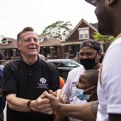 Father Michael Pfleger hugs supporters outside St. Sabina Church after the Archdiocese of Chicago announced that Pfleger will return to his role at senior pastor at the Auburn Gresham church, Monday afternoon, May 24, 2021. The archdiocese cleared him to return after an internal probe into decades-old allegations of sexual abuse against minors.