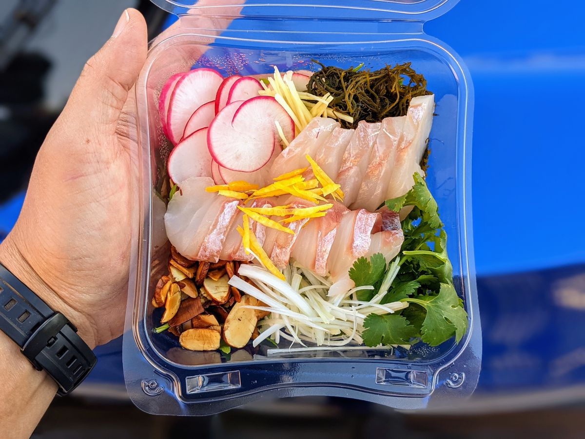 Line-caught sashimi plate in a plastic takeout container.