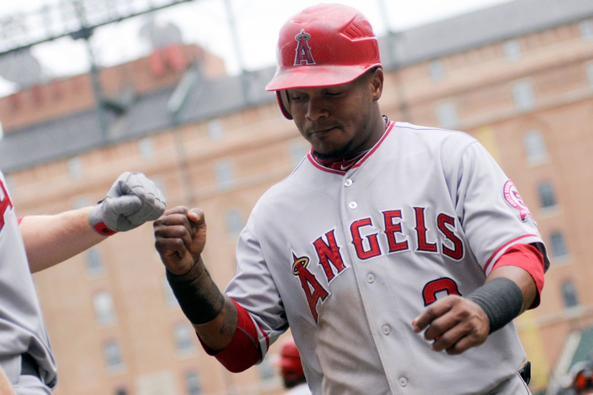 Erick Aybar #2 of the Los Angeles Angels of Anaheim bumps fists with teammates.