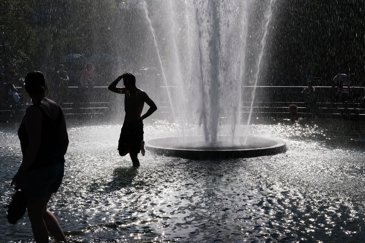 People cool off in a fountain in Washington Square Park on a hot afternoon in Manhattan on June 27, 2019, in New York City.