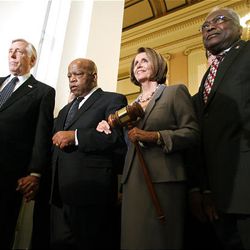 House Speaker Nancy Pelosi, D-Calif., holds a large gavel as she emerges from a Democratic Caucus meeting with from left, Reps. Steny Hoyer, D-Md., John Lewis, D-Ga., and at right is Rep. Jim Clyburn, Sunday on Capitol Hill in Washington.
