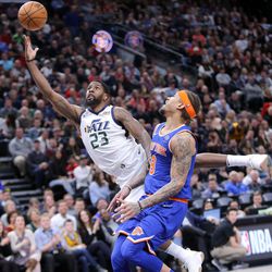 Utah Jazz forward Royce O'Neale (23) dives past New York Knicks forward Michael Beasley (8) to shoot during a basketball game at the Vivint Smart Home Arena in Salt Lake City on Friday, Jan. 19, 2018.