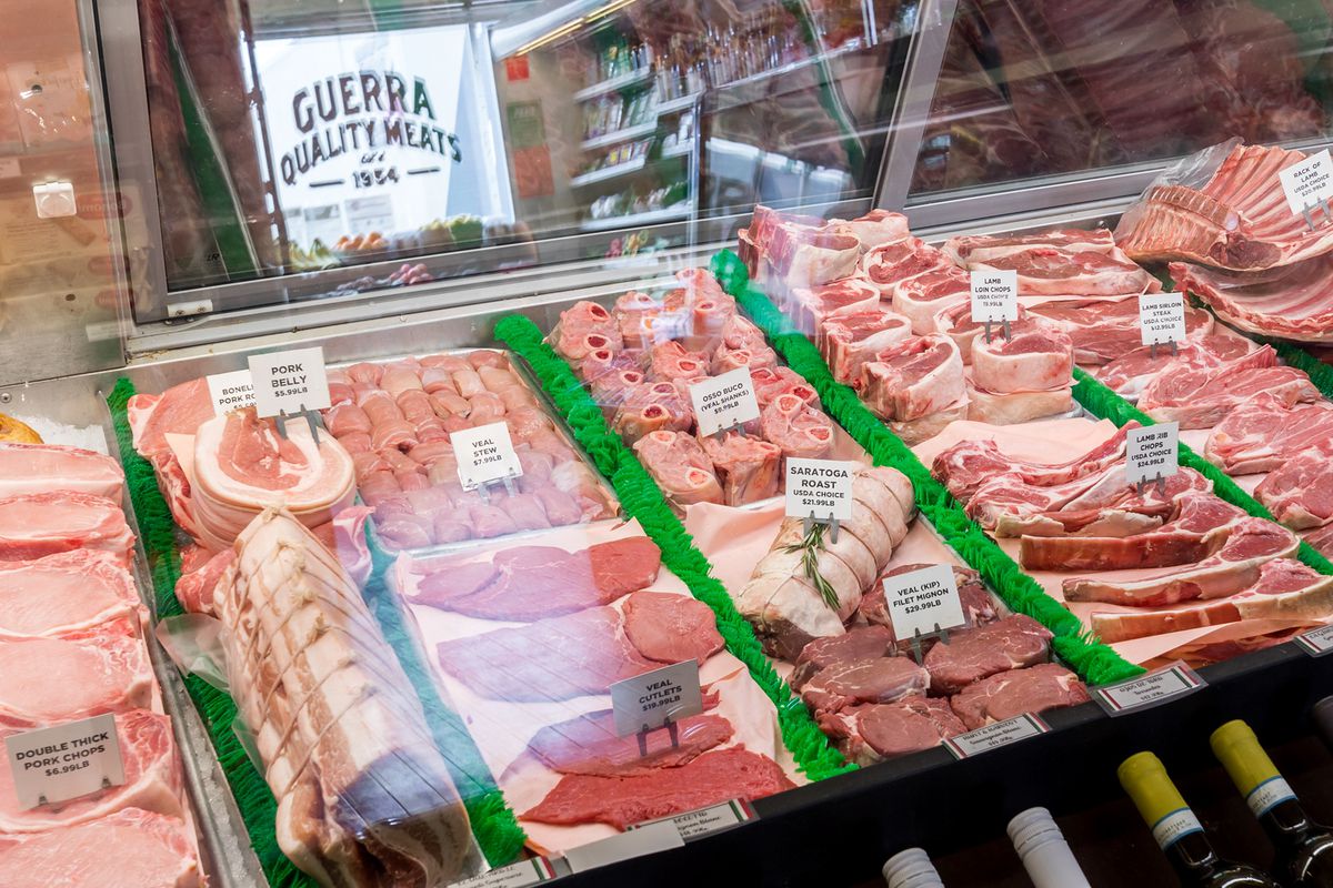A deli case of raw meats.