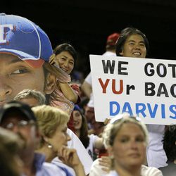 Texas Rangers' Yu Darvish fans hold up a picture of his likeness with a sign that reads "We Got YUr Back Darvish", during a baseball game against the Pittsburgh Pirates, Monday, Sept. 9, 2013, in Arlington, Texas. 