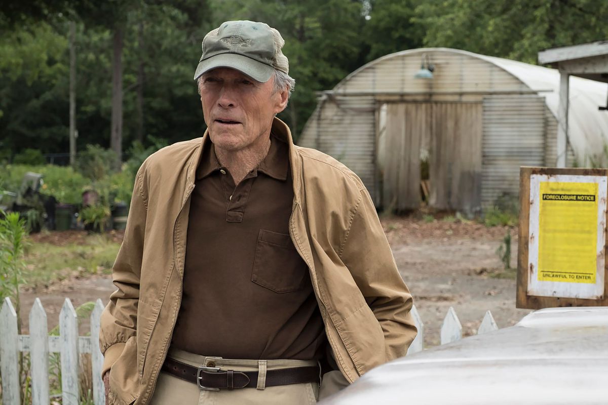 Clint Eastwood wearing a brown shirt, tan jacket, tan pants, and a gray hat in The Mule.