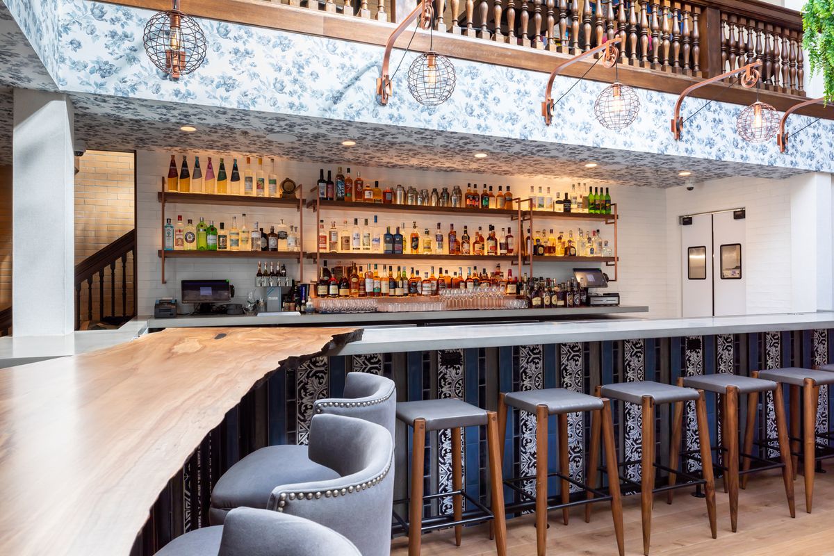 The curved bar at Ettan with grey stools and a minimalist back bar.