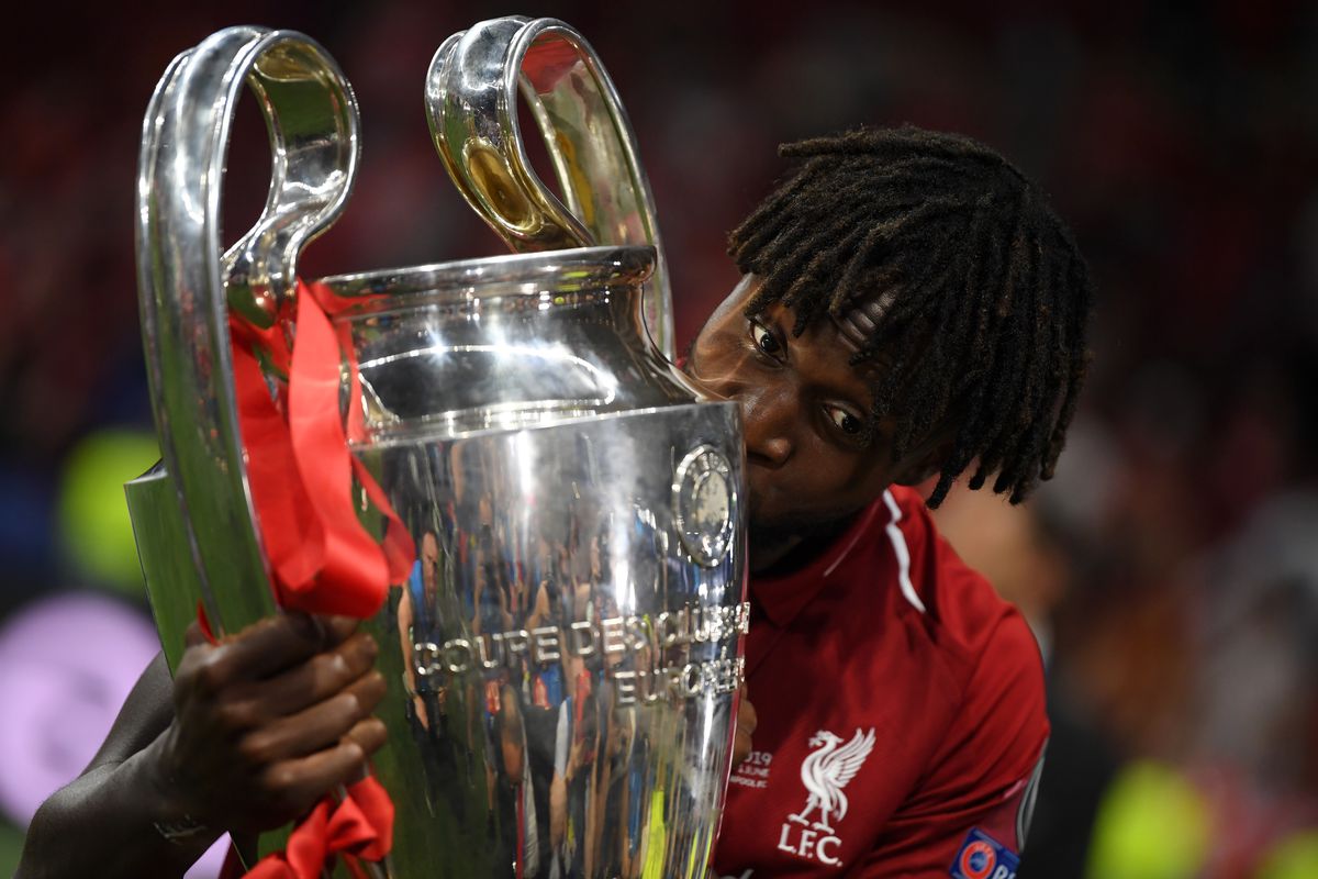 Divock Origi of Liverpool celebrates with the Champions League Trophy after winning the UEFA Champions League Final between Tottenham Hotspur and Liverpool at Estadio Wanda Metropolitano on June 01, 2019 in Madrid, Spain.