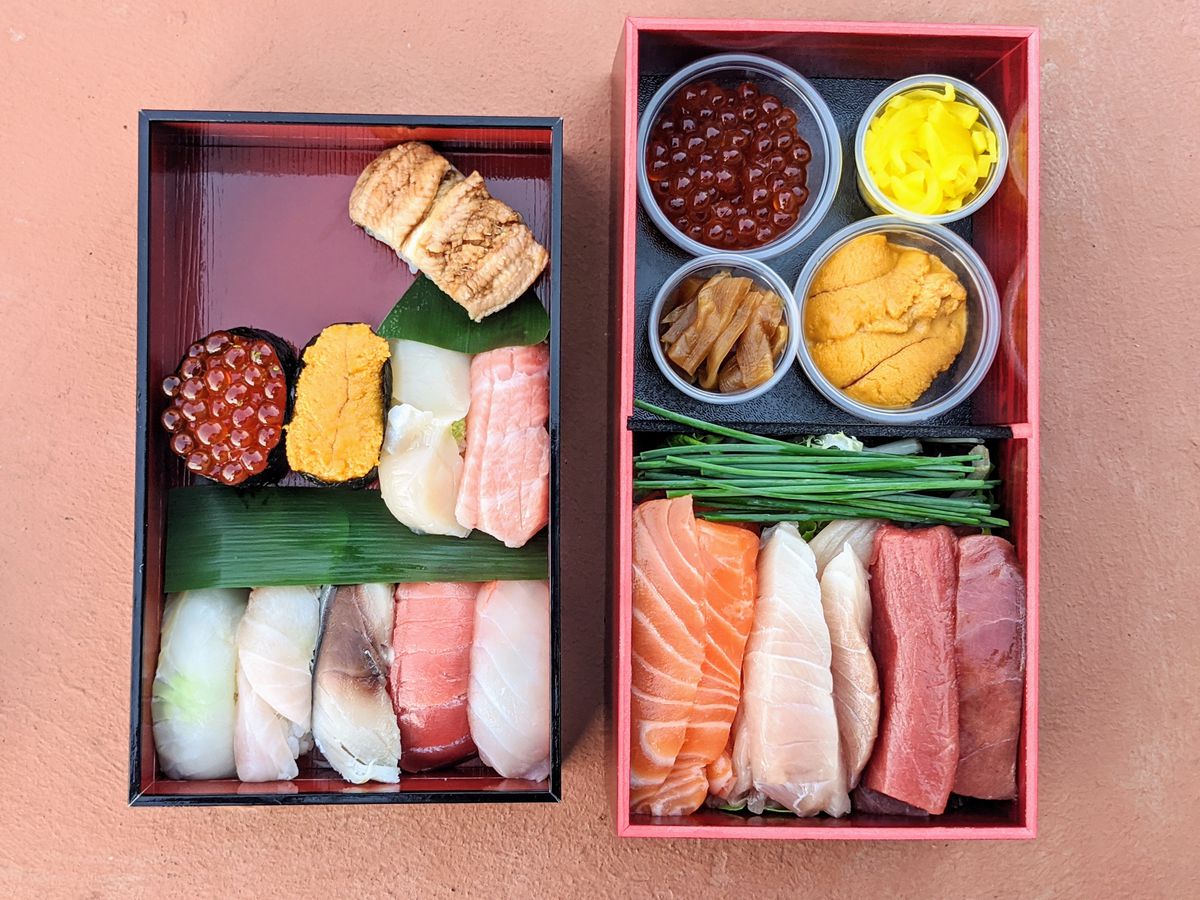 A collection of fresh sushi and nigiri in a simple box.