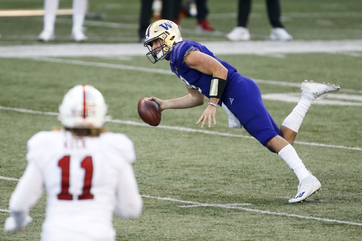 Washington Huskies quarterback Dylan Morris (9) stumbles after escaping a sack against the Stanford Cardinal during the fourth quarter at Alaska Airlines Field at Husky Stadium.