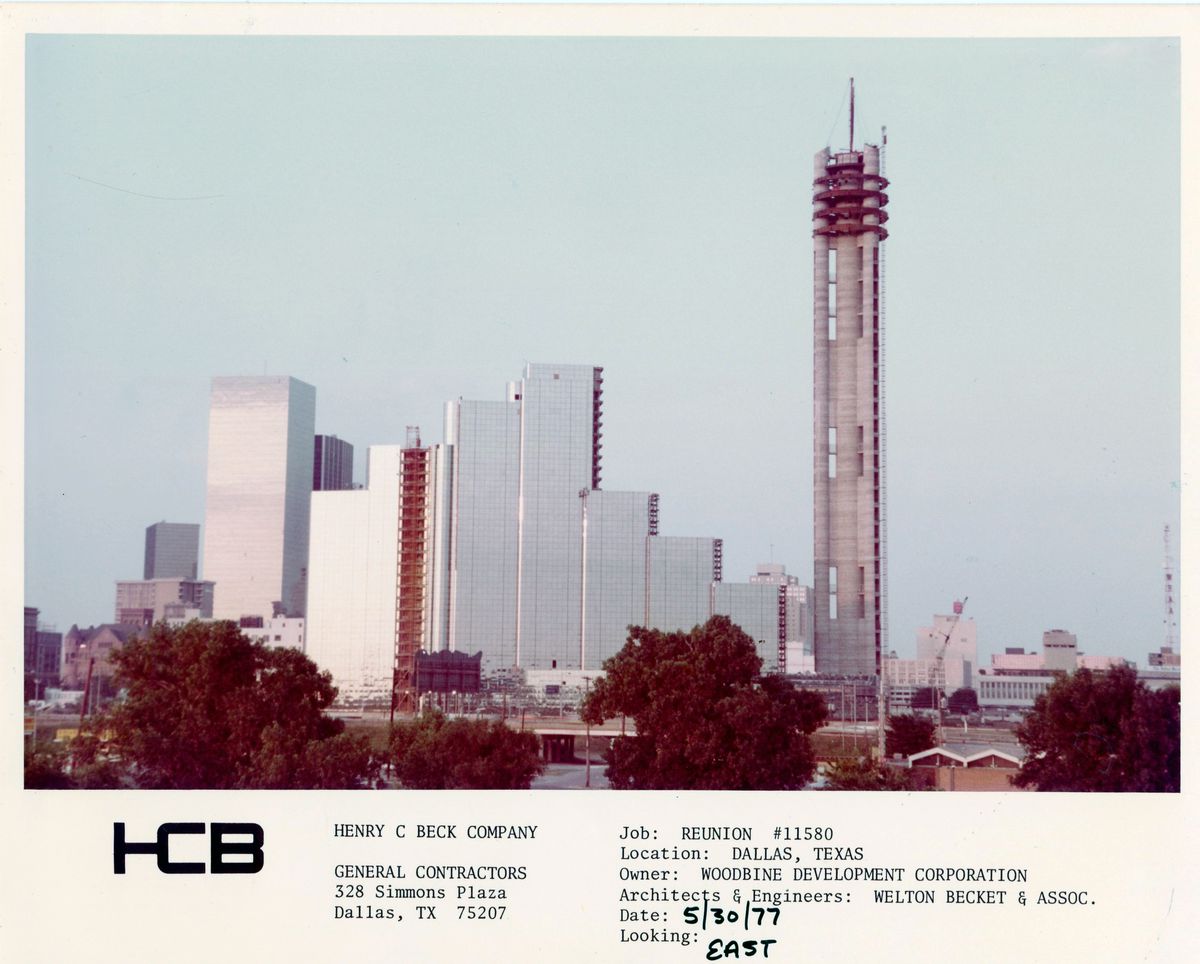 A skyline shot shows the Hyatt Hotel and Reunion Tower in Downtown Dallas as they are being built. The hotel is incomplete and the Tower is only its base.
