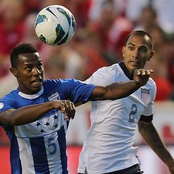 Honduras' Jose Valasquez (5) keeps his eyes on the ball with Edgar Castillo (2) of the U.S. trailing behind as the United States and Honduras play Tuesday, June 18, 2013 at Rio Tinto Stadium. USA beat Honduras 1-0.