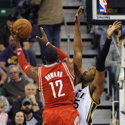 Houston Rockets power forward Dwight Howard (12) works around the defense of Utah Jazz power forward Derrick Favors (15) during a game at EnergySolutions Arena on Monday, Dec. 2, 2013.