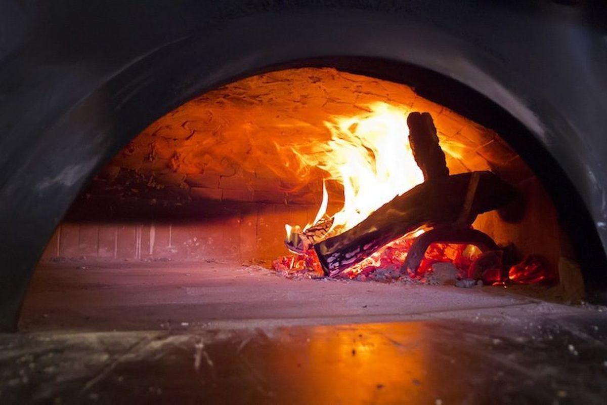 The fire rages inside the pizza oven, which has been lit since its installation. Sort of like the eternal flame, only for pizza.