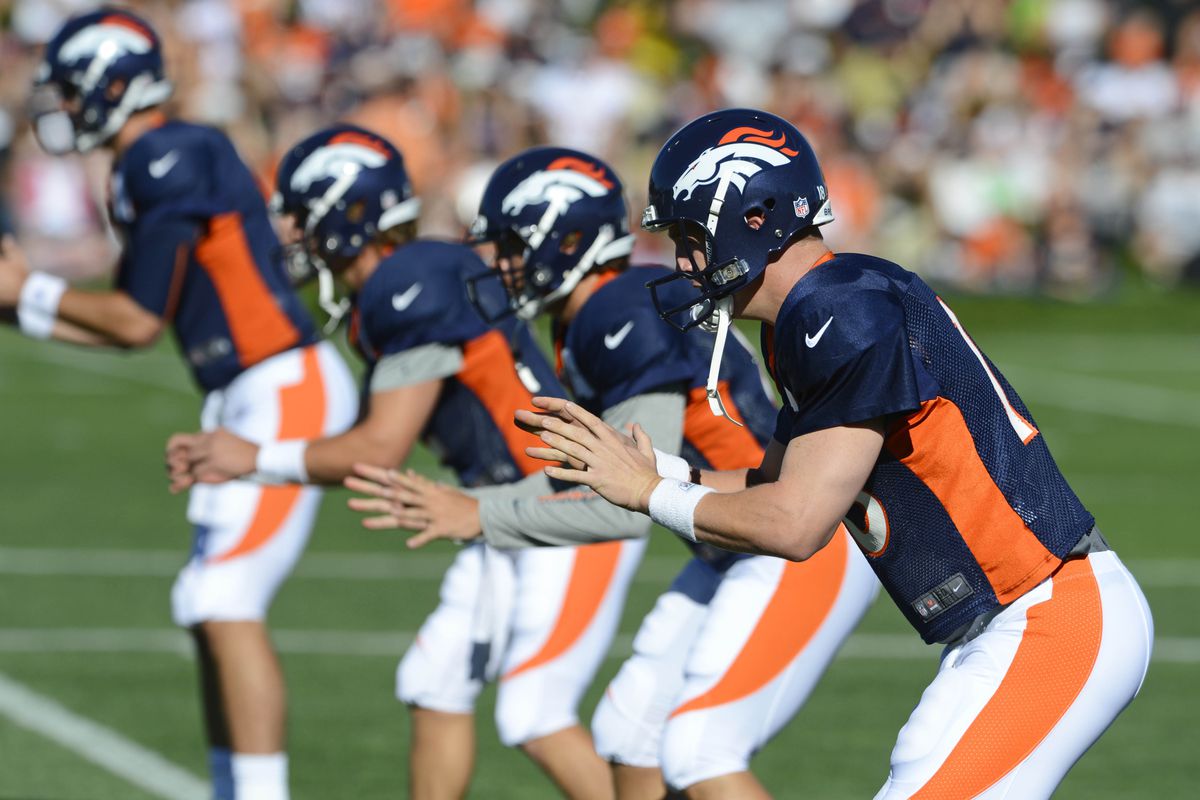 July 28, 2012; Englewood, CO, USA; Denver Broncos quarterback Peyton Manning (18) warms up before the start of training camp at the Broncos training facility. Mandatory Credit: Ron Chenoy-US PRESSWIRE
