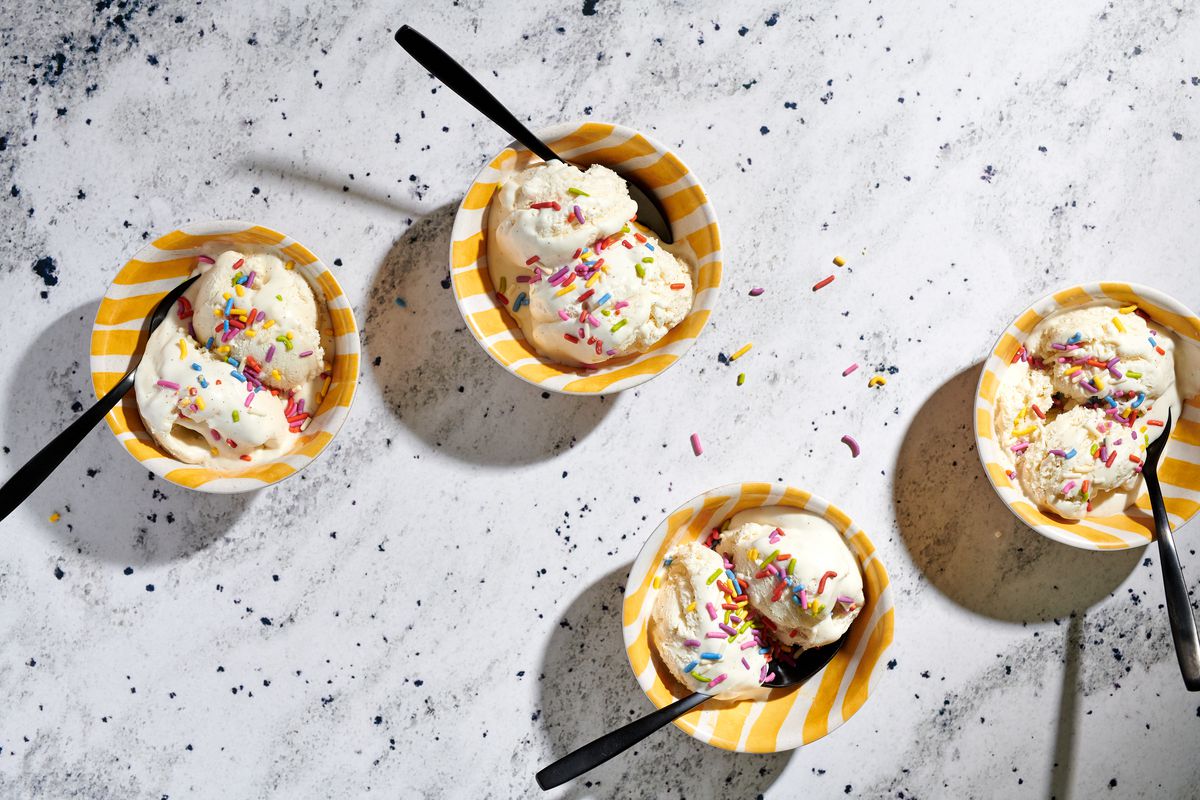 Bowls of vanilla ice cream, covered with rainbow sprinkles.