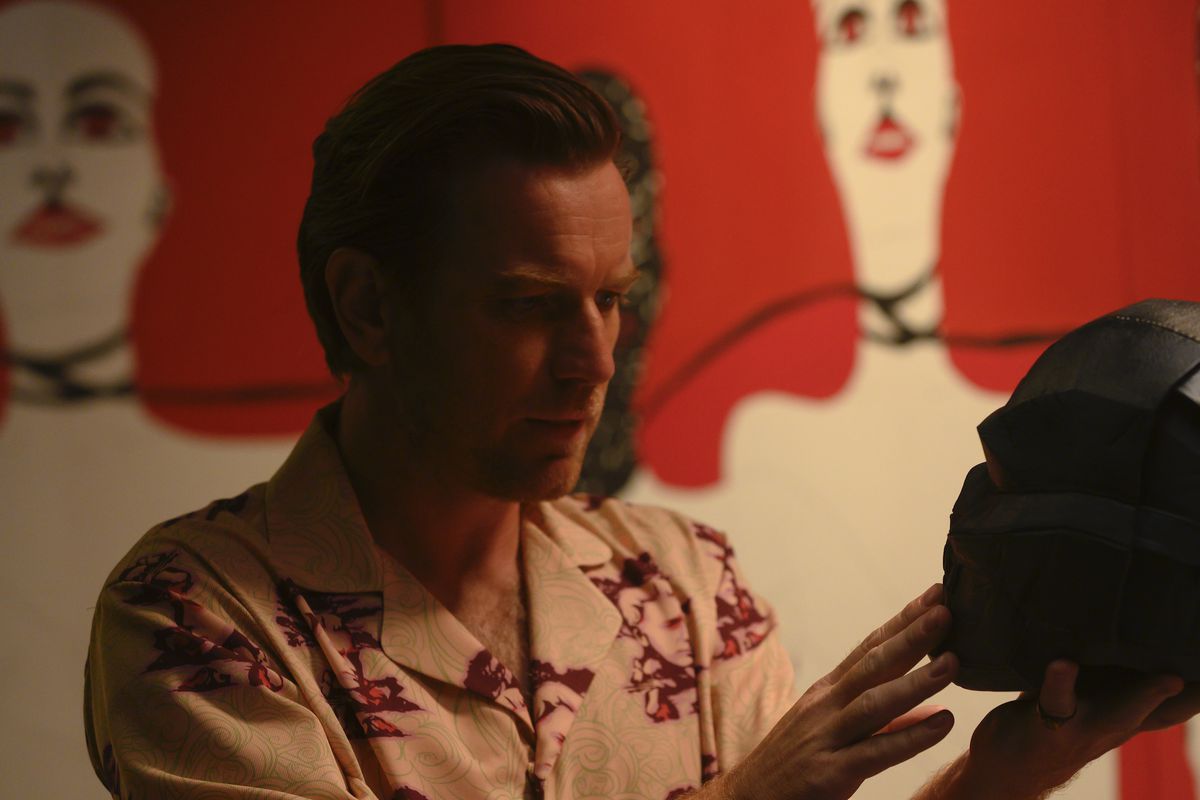 EWAN McGREGOR considers his literal black mask as Roman Sionis in Warner Bros. Pictures’ “BIRDS OF PREY (AND THE FANTABULOUS EMANCIPATION OF ONE HARLEY QUINN).