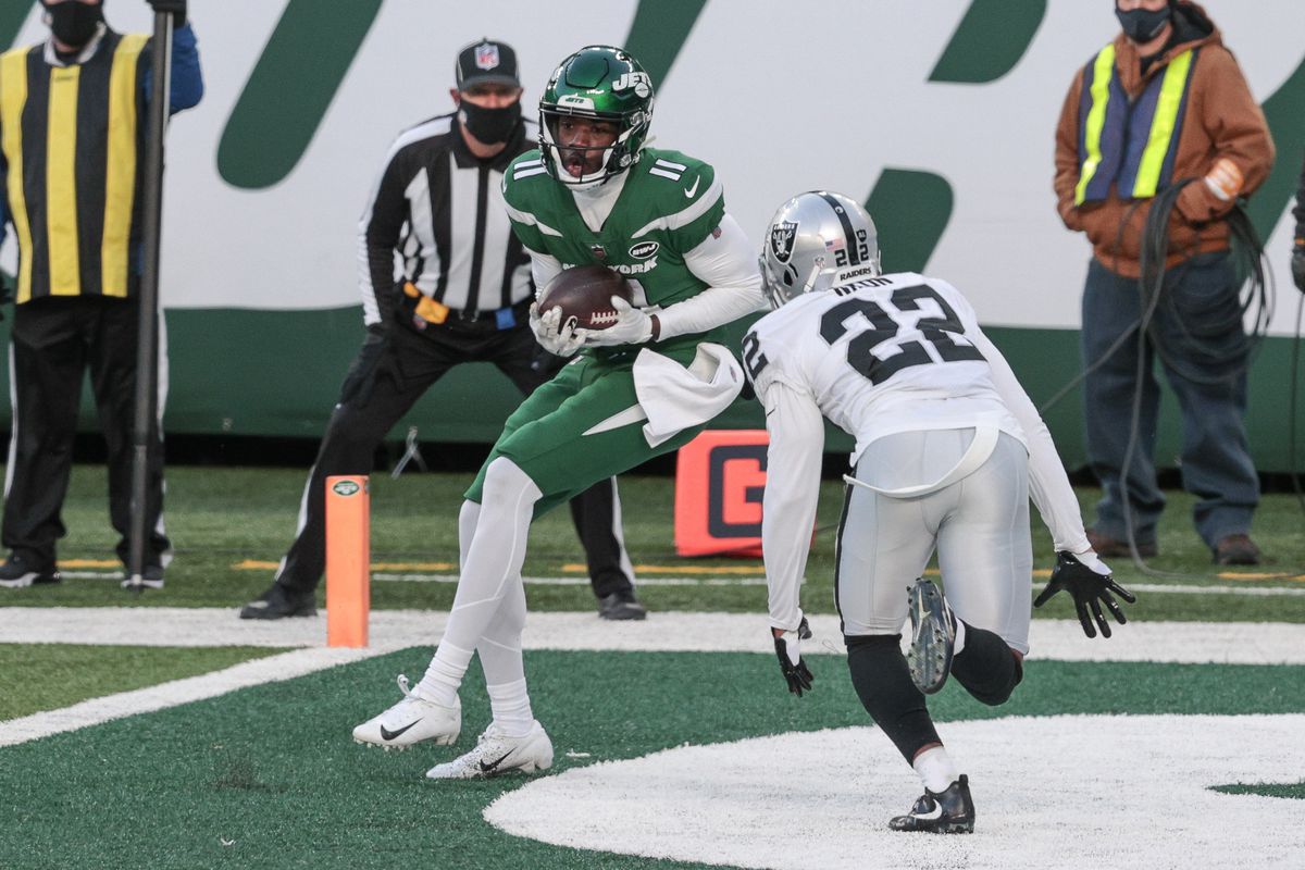 New York Jets wide receiver Denzel Mims (11) catches the ball for a two point conversion in front of Las Vegas Raiders cornerback Keisean Nixon (22) during the second half at MetLife Stadium.