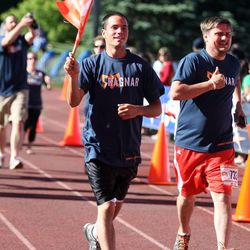 Brandon Winters crosses the finish line of the Wasatch Back Ragnar Relay at Park City High School in Park City on Saturday, June 22, 2013.