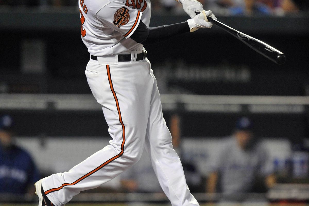 Manny Machado (13) singles in the sixth inning against the Toronto Blue Jays at Oriole Park at Camden Yards.  Mandatory Credit: Joy R. Absalon-US PRESSWIRE