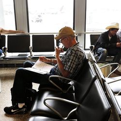 Steve Million uses a smoking room at Salt Lake City International Airport, Monday, Aug. 3, 2015.