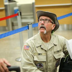 Ken Smith, a member of Utah's Disaster Medical Assistance Team, waits in line for a boarding pass at the Salt Lake City International Airport on Tuesday, Aug. 29, 2017. The 36-member team is flying to Texas to aid in Hurricane Harvey relief efforts. The team consists of physicians, nurses, paramedics, emergency medical technicians and other medical specialists.