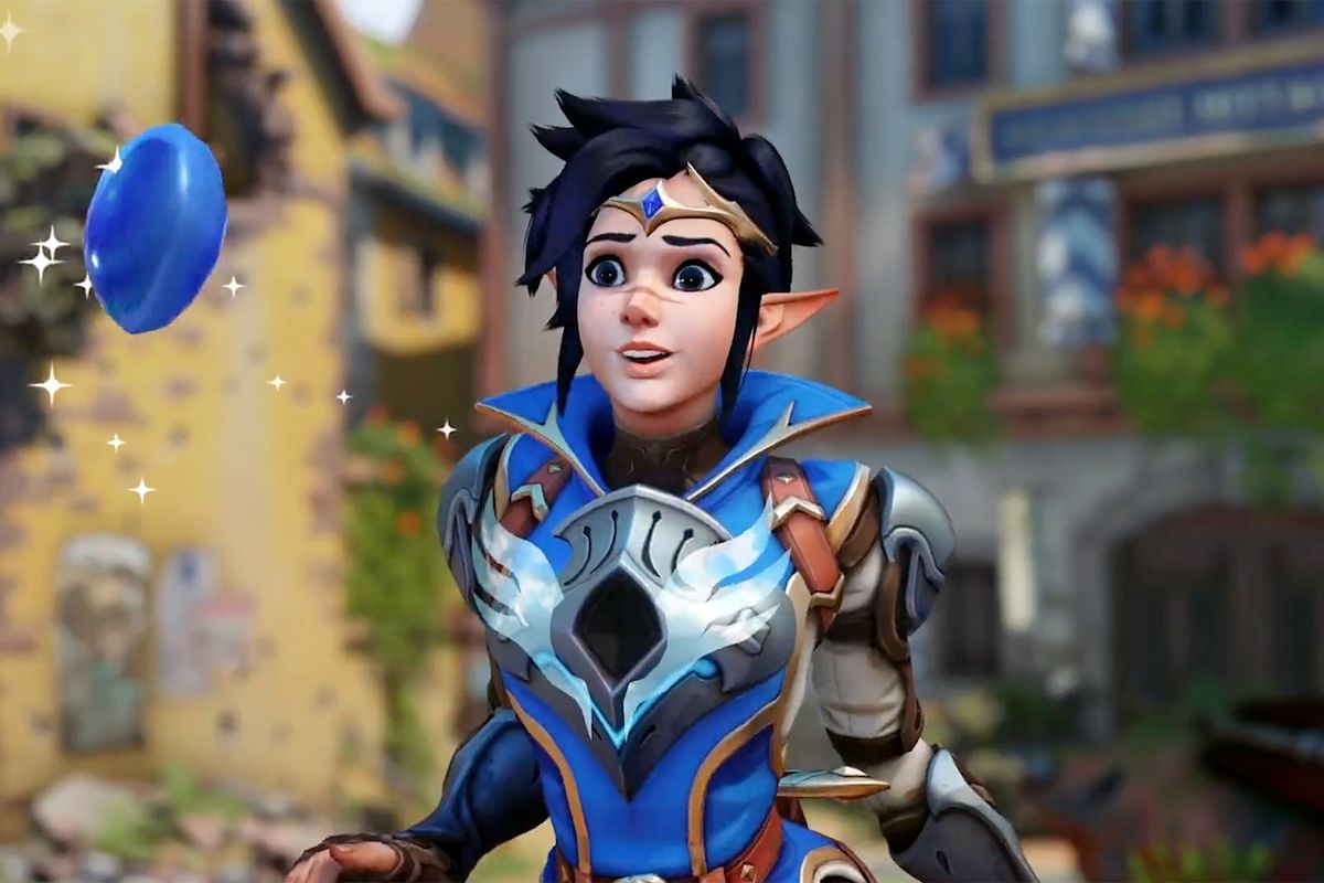 Tracer, wearing her elf-like Mythic Adventurer skin, looks at a flying blue gem in a screenshot from Overwatch 2