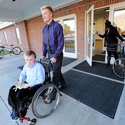 Nathan Honey and his mother Sharon wolk out of church with Joshua and Andrew  Sunday, Nov. 16, 2014. Nathan is an American Fork High football player and helps out with his four brothers who struggle with muscular dystrophy. 