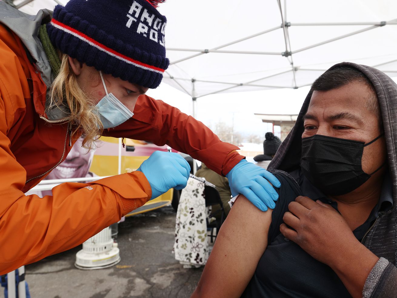 Tristin Torkelson, an EMT with Salt Lake County, gives Raymundo Altamirano a COVID-19 vaccination at a Salt Lake County Health Department mobile site at Tejeda’s Market in Salt Lake City on Wednesday, Dec. 29, 2021.