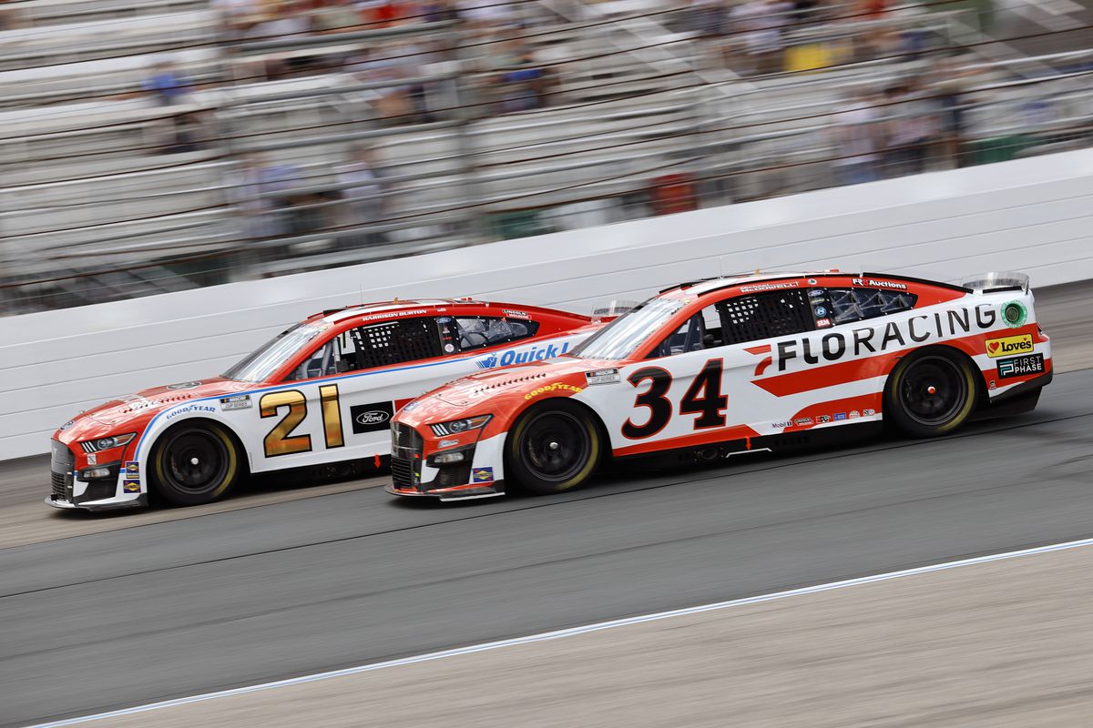 Harrison Burton, driver of the #21 Motorcraft/Quick Lane Ford, and Michael McDowell, driver of the #34 FloRacing Ford, race during the NASCAR Cup Series Ambetter 301 at New Hampshire Motor Speedway on July 17, 2022 in Loudon, New Hampshire.