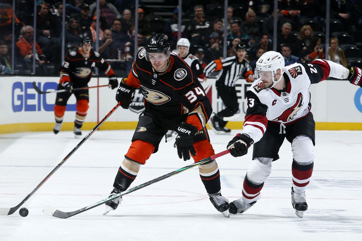 Sam Steel #34 of the Anaheim Ducks skates with the puck with pressure from Oliver Ekman-Larsson #23 of the Arizona Coyotes during the game at Honda Center on January 29, 2020 in Anaheim, California.