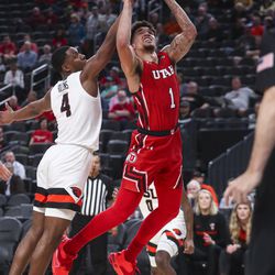 Utah Utes forward Timmy Allen (1) gets fouled by Oregon State Beavers forward Alfred Hollins (4) as Utah and Oregon State meet during the first round of the Pac-12 men’s basketball tournament at T-Mobile Arena in Las Vegas on Wednesday, March 11, 2020.
