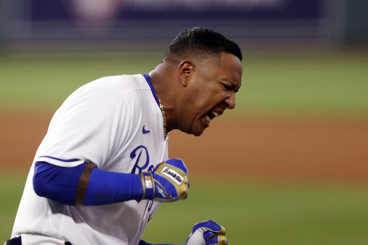 Salvador Perez #13 of the Kansas City Royals celebrates a walk-off single to end the game as Nicky Lopez #8 scores during the bottom of the 9th inning against the Tampa Bay Rays at Kauffman Stadium on April 21, 2021 in Kansas City, Missouri. 