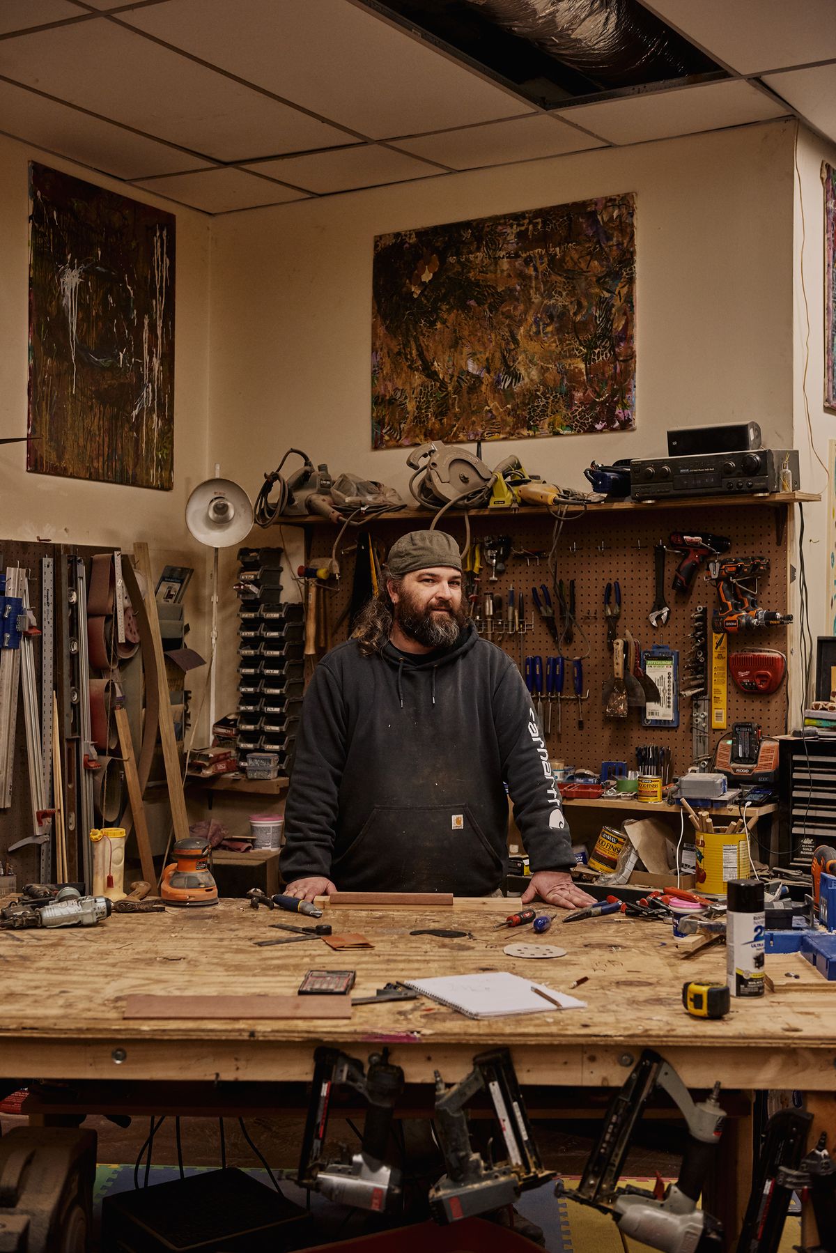 A bearded artisan at his workbench. 