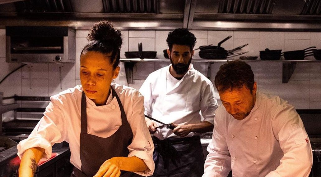Carly, played by Vinette Robinson, and Andy, Stephen Graham, at the pass in the dimly lit kitchen with Freeman, played by Ray Panthaki behind