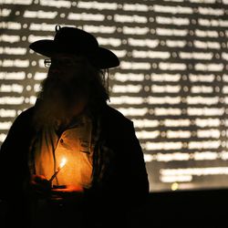 Carl Spitzmacher holds a candle during a candlelight vigil in Salt Lake City on Thursday, Dec. 20, 2018, at Pioneer Park to remember the 121 homeless men and women who died during the year. Spitzmacher lost a close homeless friend recently.